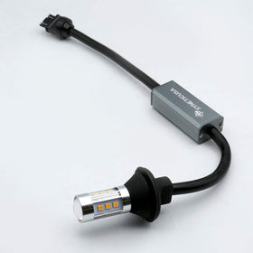 Syneticusa lit amber turn signal in use showing enhanced daytime visibility