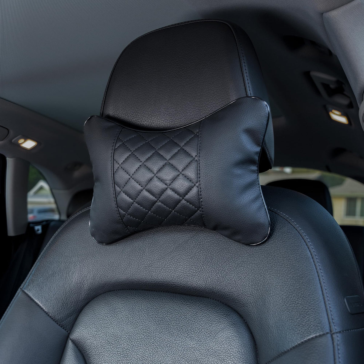 Synterior front view of two black headrest pillows showing coordinated style and comfort
