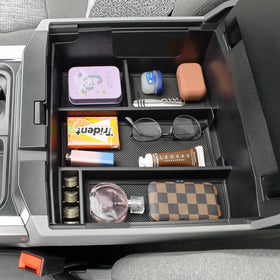TACOBRO compartment detail holding cables, coins, and sunglasses for fast retrieval