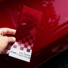 TCP Global card held beside a hand and spray gun showing card size utility