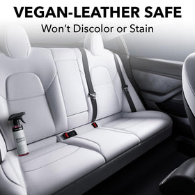 TesLiner spray in use on a Tesla seat demonstrating targeted stain lifting
