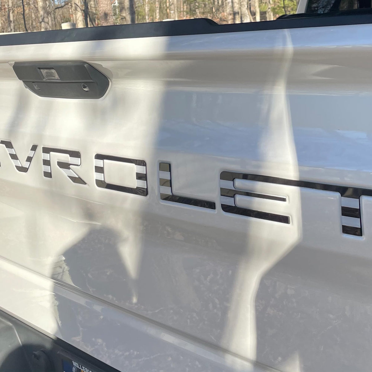 Texflic letters held in hand to show scale and precise fit for Silverado