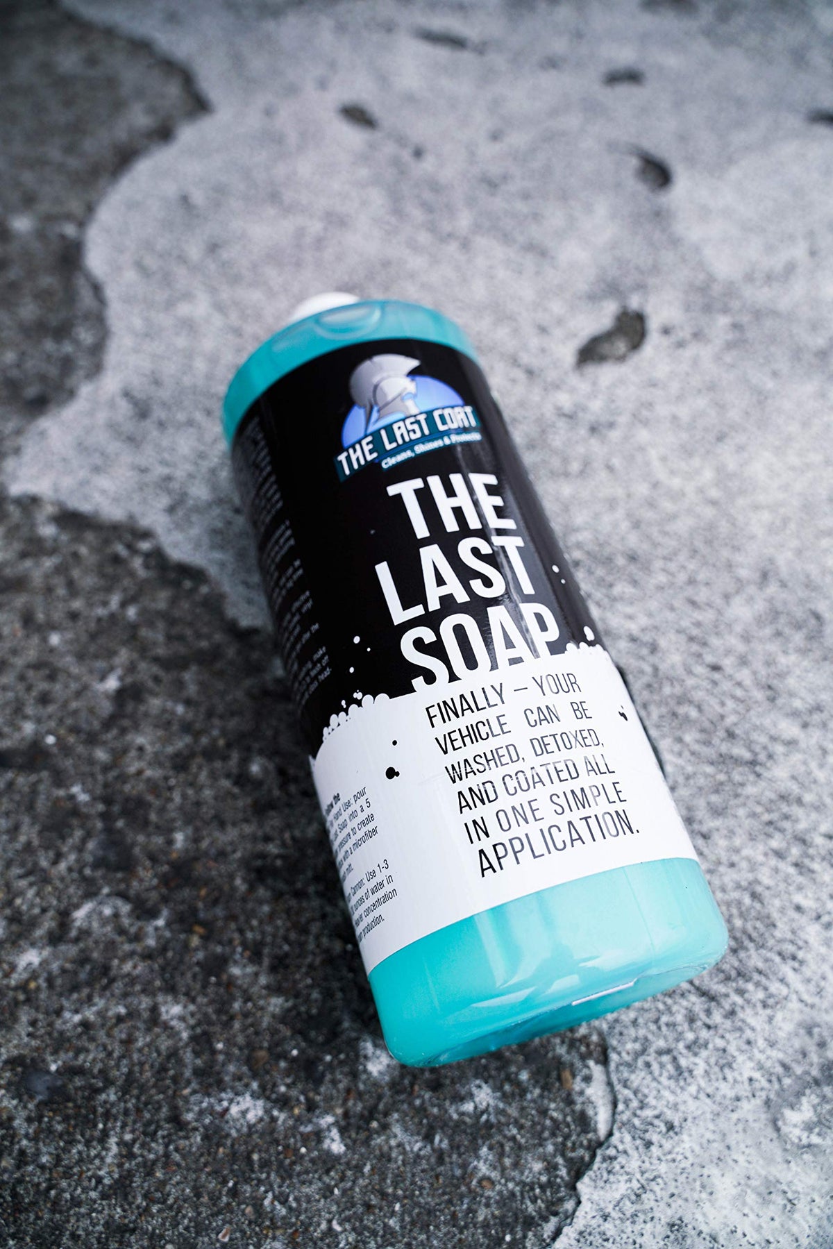 The Last Coat bottle held in hand showing compact 32 oz size
