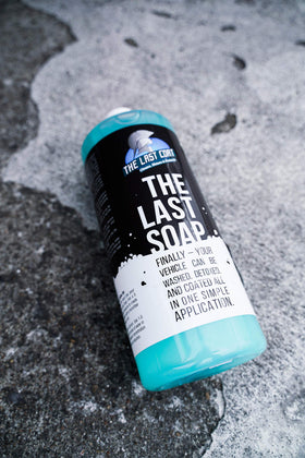 The Last Coat bottle held in hand showing compact 32 oz size