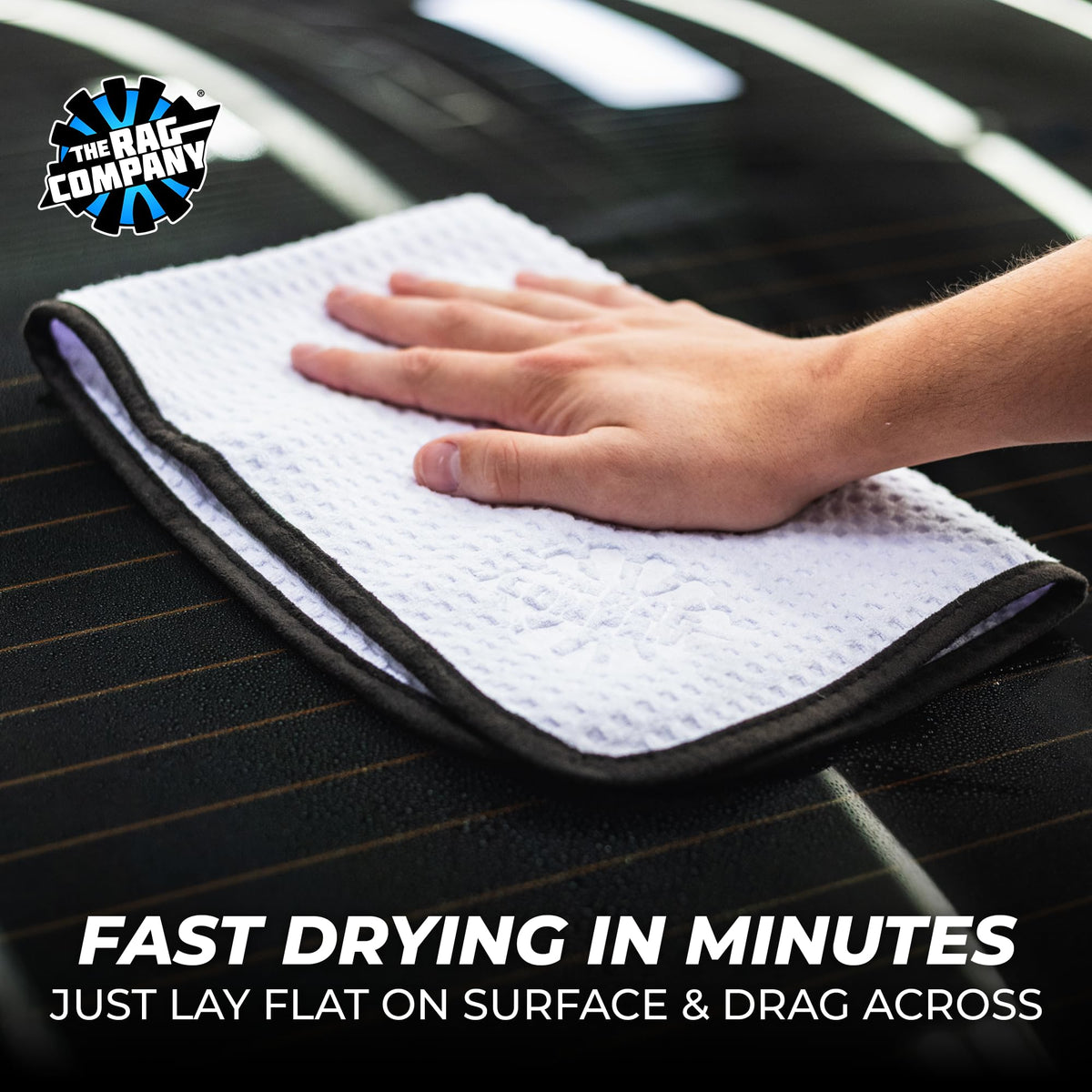 The Rag Company towel absorbing water from a car hood to demonstrate fast water pickup