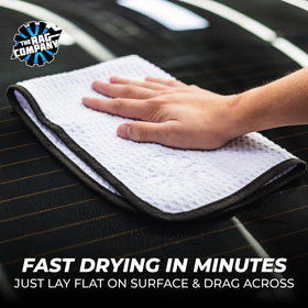 The Rag Company towel absorbing water from a car hood to demonstrate fast water pickup
