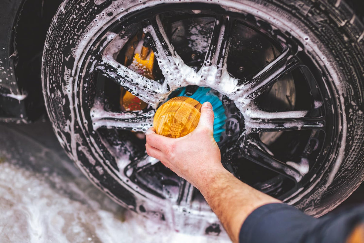The Rag Company brush applying tire dressing showing even product distribution benefit