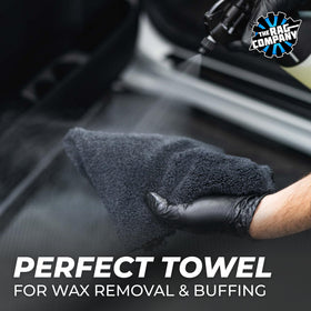 Hand holding The Rag Company towel showing 16x16 size and easy handling benefit