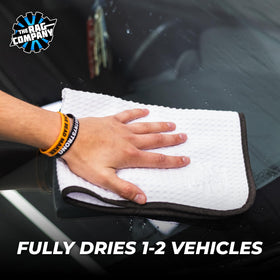 The Rag Company towel wiping a mirror delivering streak-free results on glass