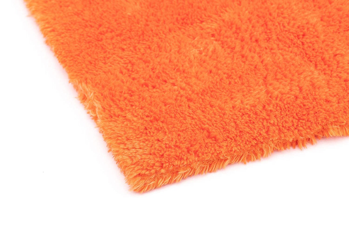 The Rag Company towel held in hand showing 16x16 scale and plush comfort