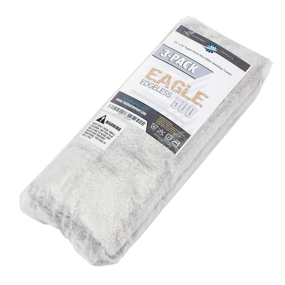 Hand holding The Rag Company towel to show 16x24 size and easy control