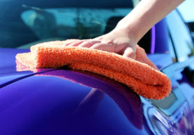 The Rag Company towel removing wax residue efficiently with minimal waste