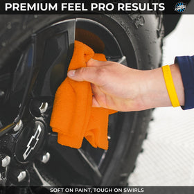 The Rag Company towel in use polishing a car hood delivering streak-free shine