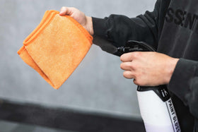 The Rag Company FTW towel drying a car window leaving a clear, lint-free finish