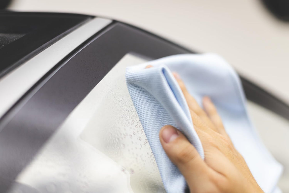 The Rag Company towel polishing car mirror in use, fast streak-free detailing benefit