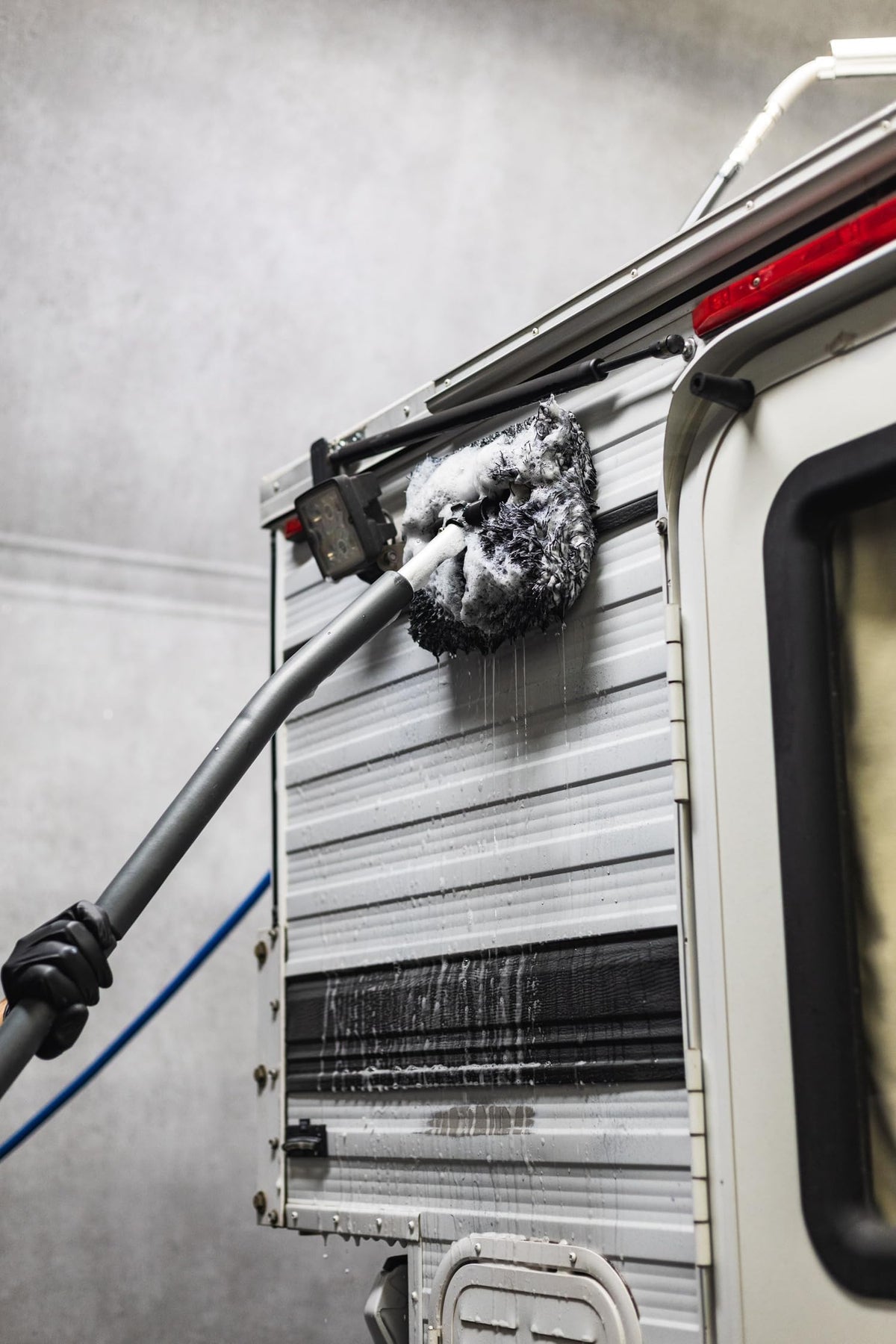The Rag Company Pro+ hanging in garage illustrating easy storage convenience
