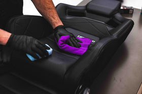 The Rag Company towel scrubbing upholstery to lift dirt without damage