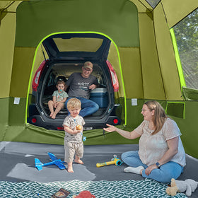 TIMBER RIDGE family enjoying campsite under porch and screened comfort