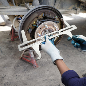 Tlence next to a hand to show compact size and easy handling in garages