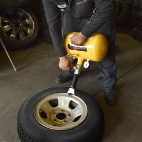 Tooluxe in use seating a tire on rim showing quick bead seating benefit