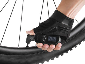 Topeak SmartGauge D2X held in hand for size and portability benefit