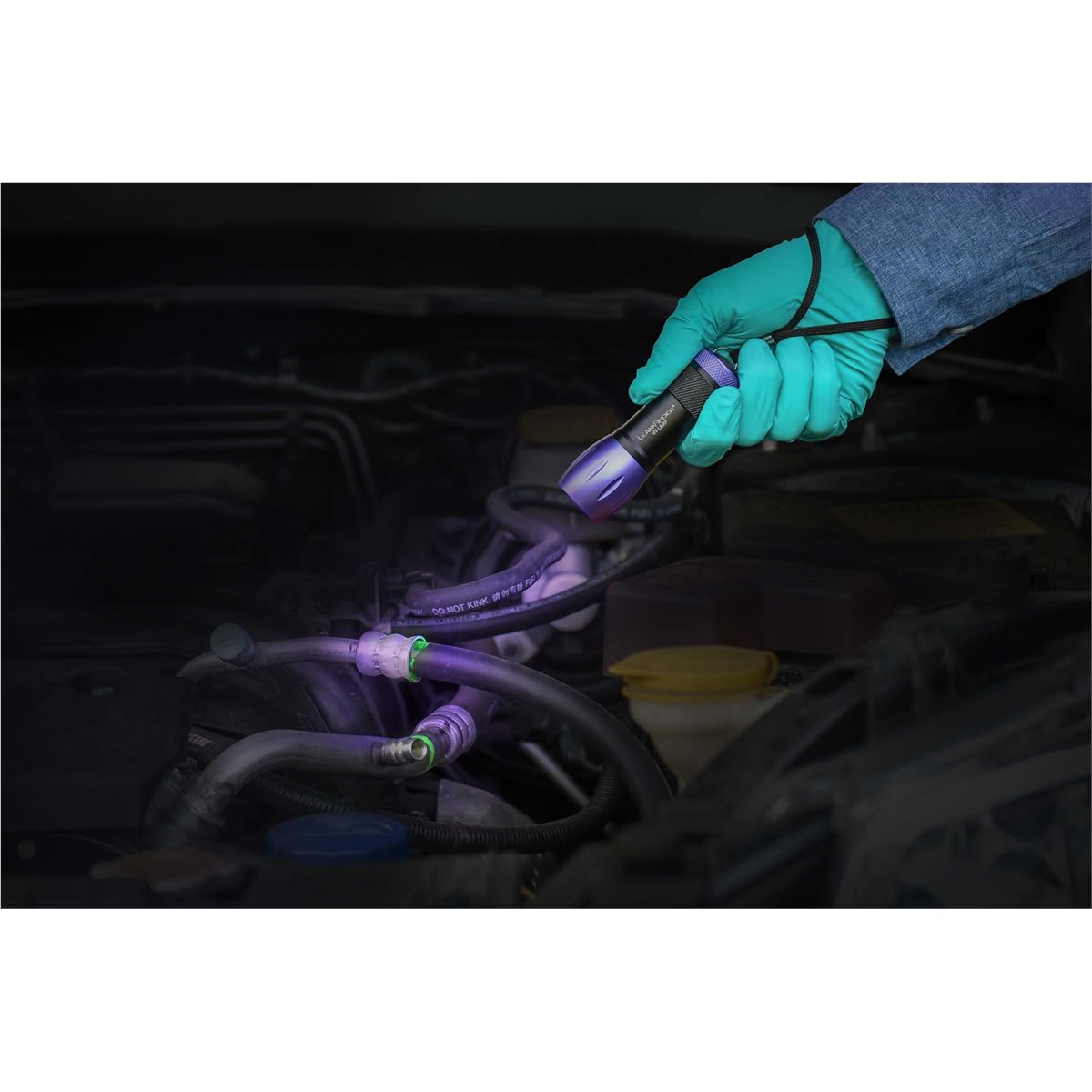 TRACER dye fluorescing under UV lamp on A/C hose, reveals leak locations quickly