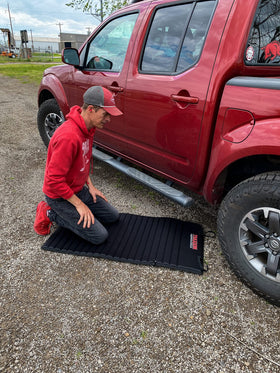 Traxion VersaMat beside tools showing size comparison and stable coverage benefit