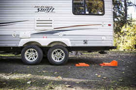 Tri-Lynx chocks positioned behind a tyre to show effective parking security and peace of mind