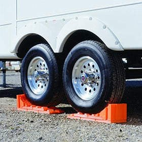 Tri-Lynx Stop N Chock in use by an RV wheel illustrating reliable stopping position