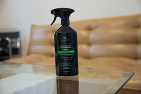 TriNova cloth applying cleaner to car seat showcasing quick cleaning and conditioning