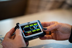 TST monitor packaging with Micro-USB cable illustrating included accessories