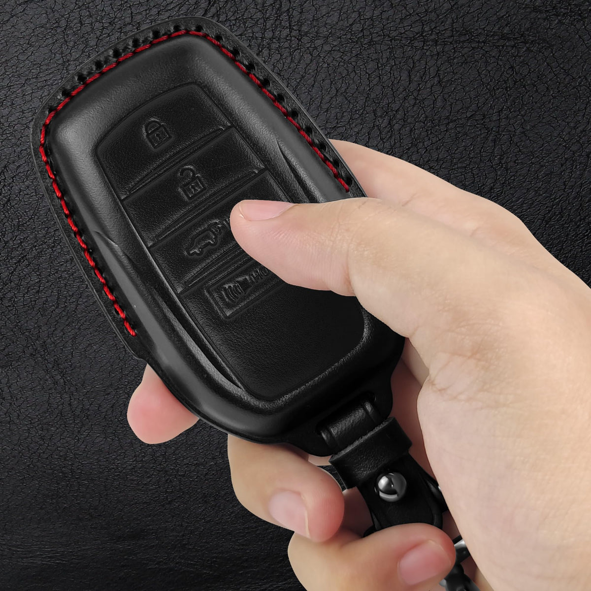 Tukellen key fob on car dashboard displaying stylish black-red accent and practical protection