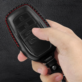 Tukellen key fob on car dashboard displaying stylish black-red accent and practical protection