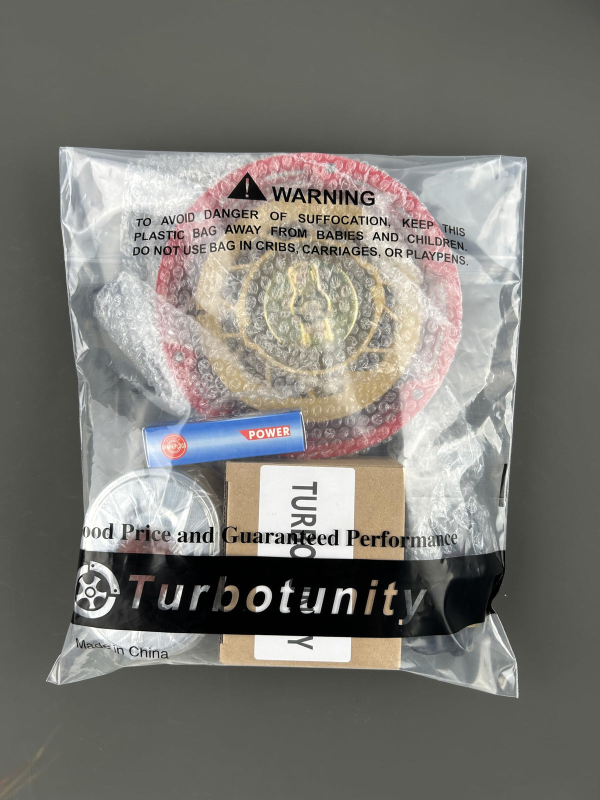 TURBOTUNITY kit beside ruler showing scale for confirming part compatibility