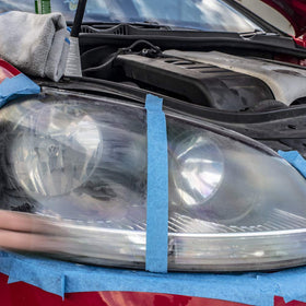 Turtle Wax side-by-side headlamp before and after restoration showing improved clarity
