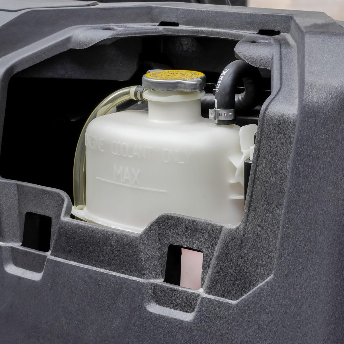 UTVSXPERT size comparison with hand showing compact fit for tight engine bays