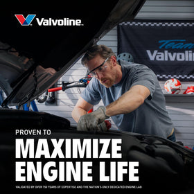 Valvoline bottle on a garage workbench next to tools conveying trusted service-ready oil
