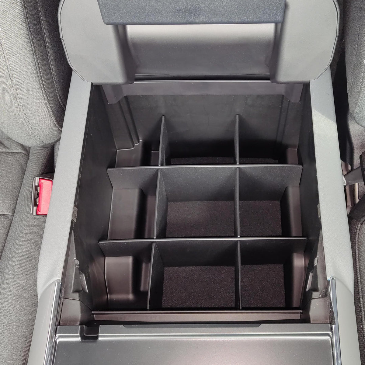 Vehicle OCD installed in Ford F150 console with lid open showing easy access advantage