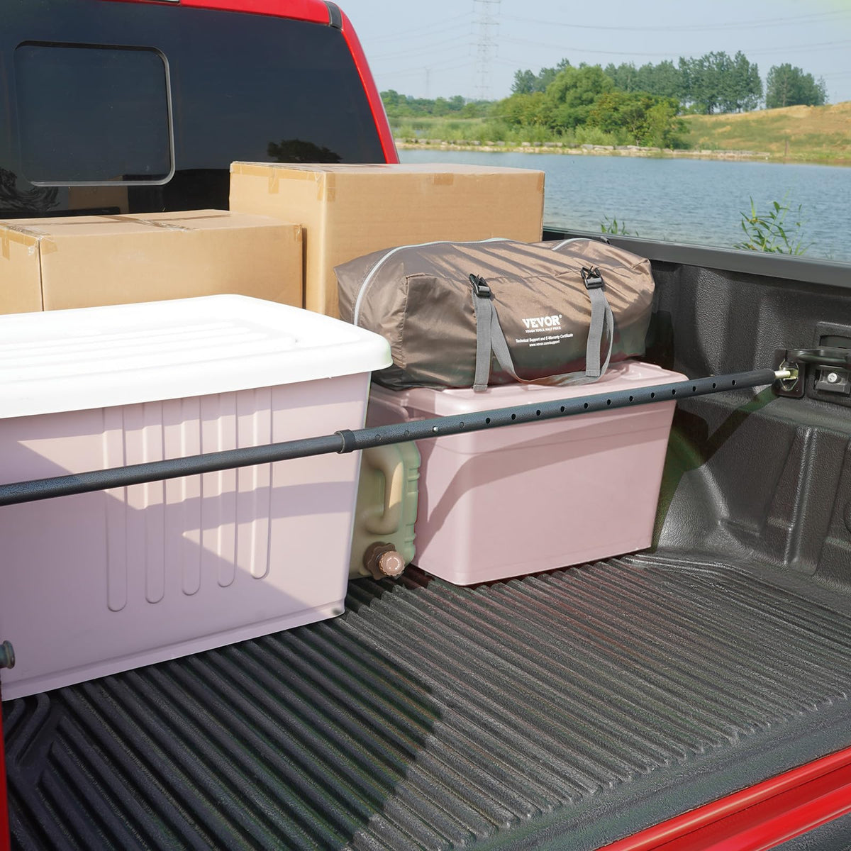 VEVOR cargo bar holding boxes in bed demonstrating 220 lb capacity and protection