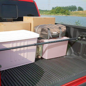 VEVOR cargo bar holding boxes in bed demonstrating 220 lb capacity and protection