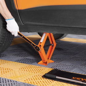 VEVOR scissor jack next to common objects showing compact size and portability