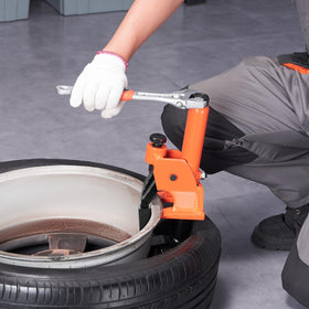 VEVOR in use on a tractor tire showing heavy-duty capability for large agricultural tires