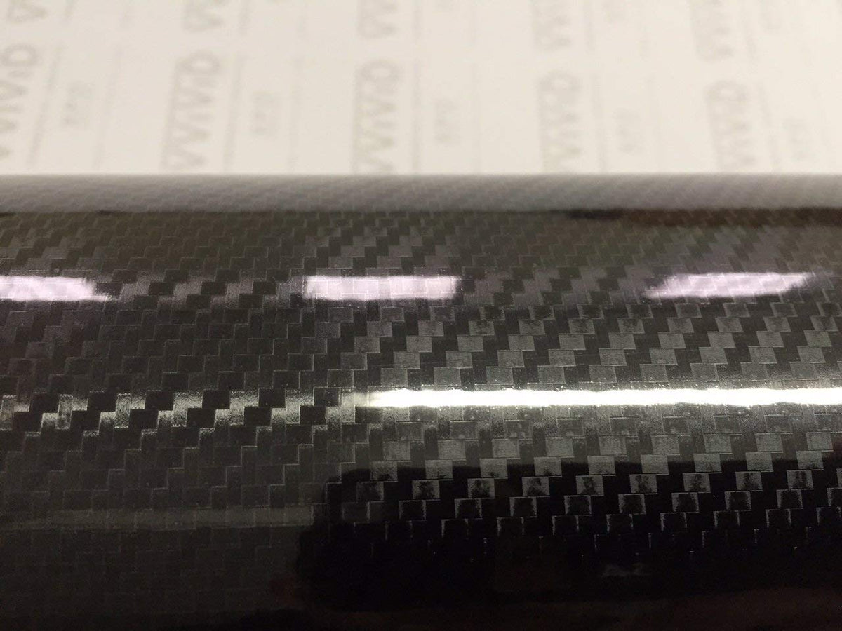 VViViD close-up of black carbon weave texture showing hyper-realistic depth