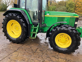 W agricultural tractor receiving foam wash for effective farm equipment care benefit