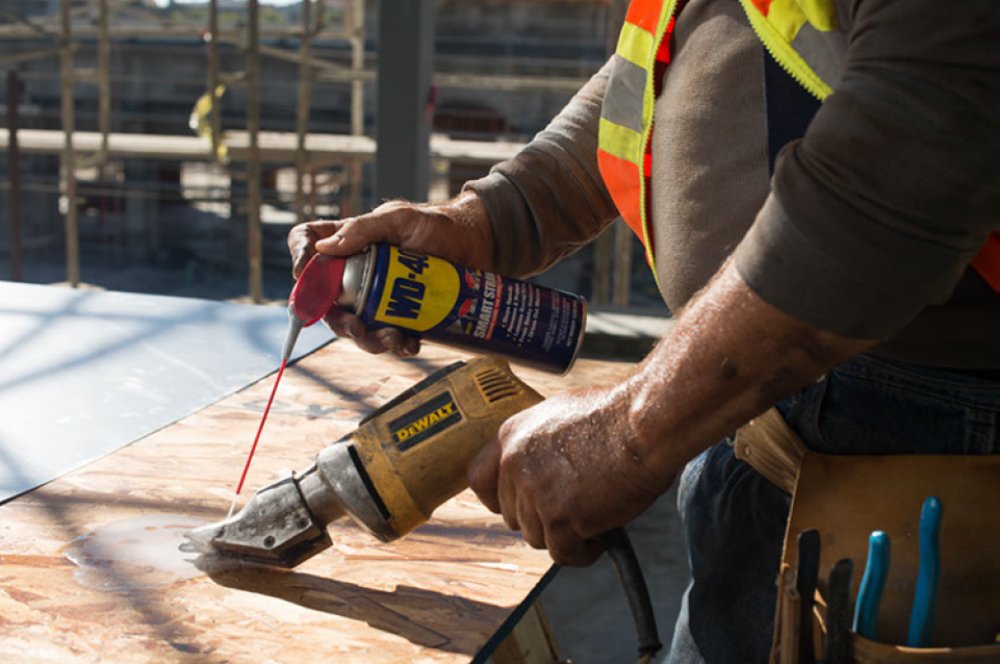 WD-40 11 oz can held in hand showing portable size for easy storage