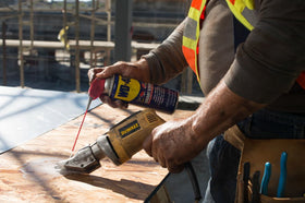 WD-40 11 oz can held in hand showing portable size for easy storage