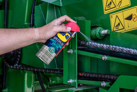 WD-40 Specialist spraying hinge to reduce friction and prevent rust