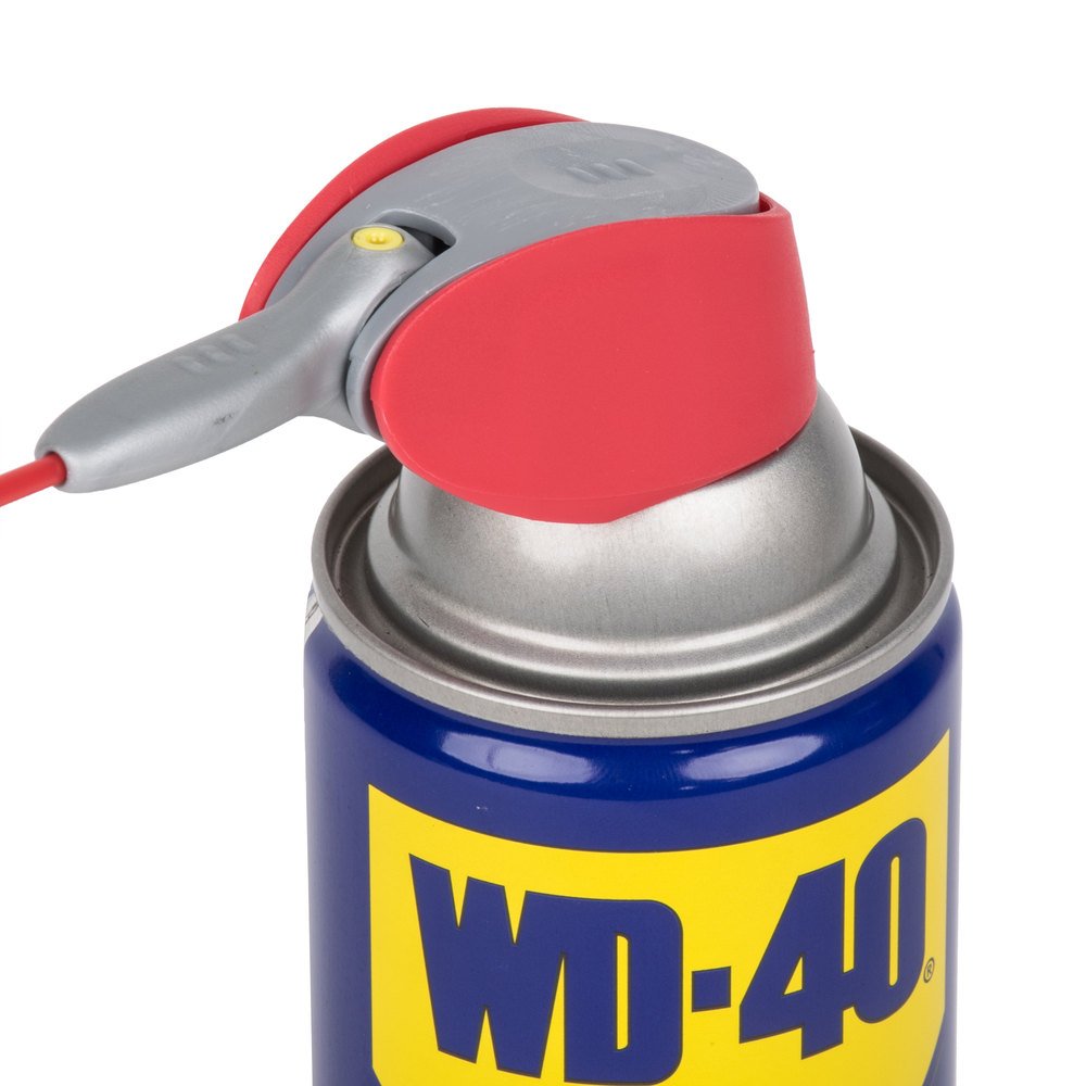 WD-40 broad spray applied to a door hinge protecting metal from moisture