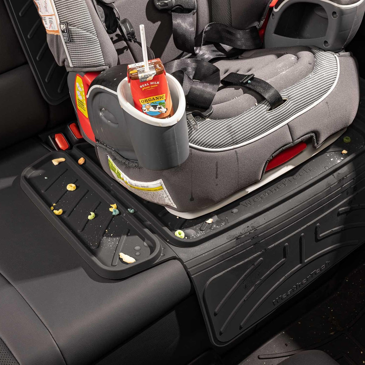 WeatherTech protector being wiped clean with cloth showing easy maintenance benefit