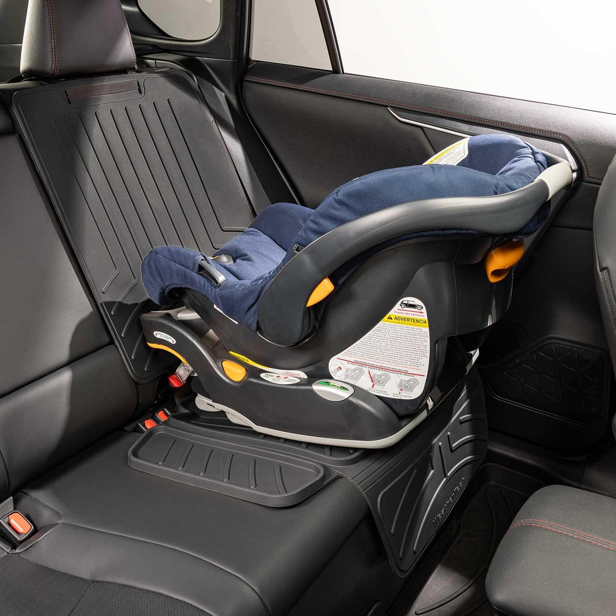 WeatherTech protector installed under a car seat demonstrating secure fit and protection